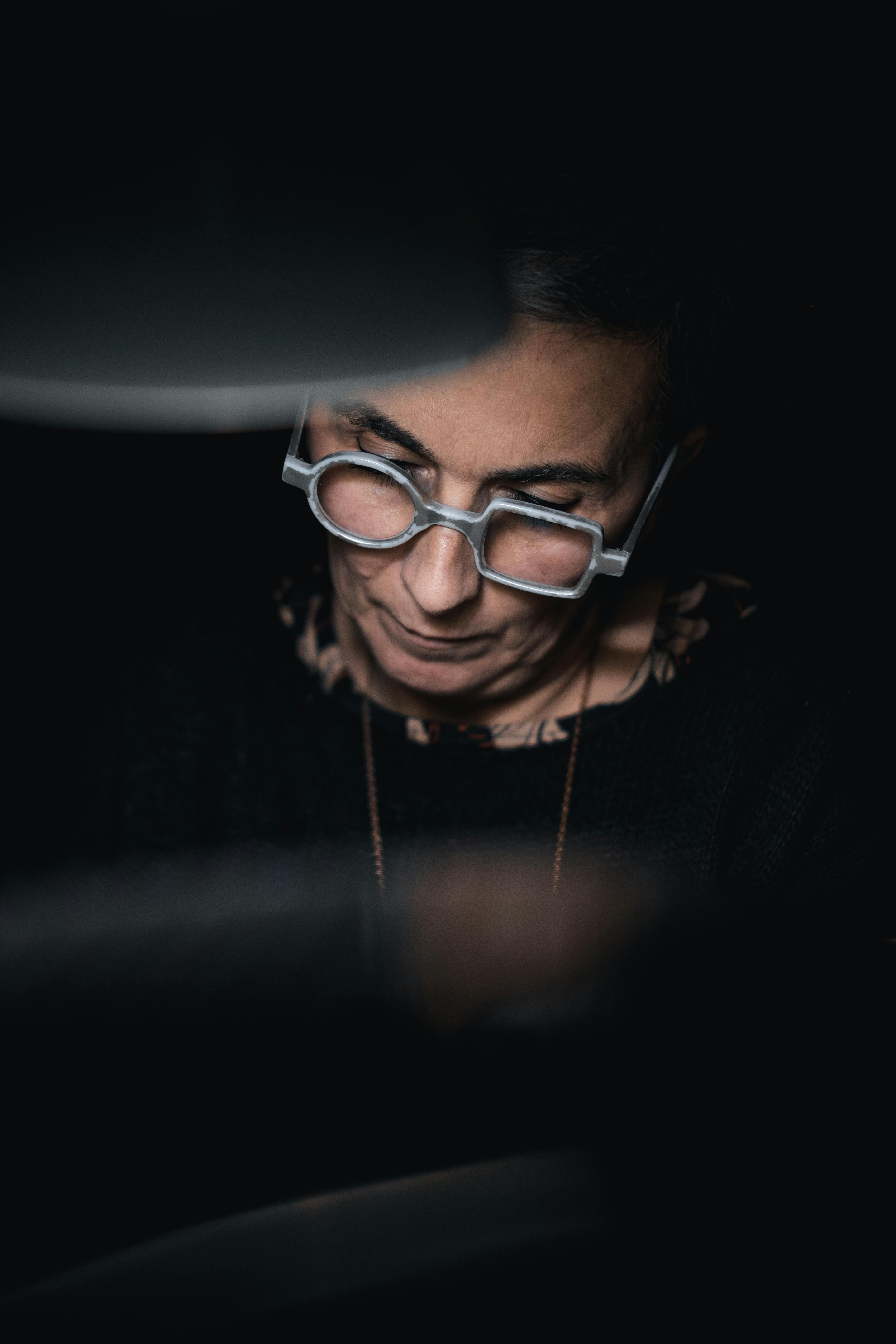 Close-up of angular geometric eyewear frames against a concrete background