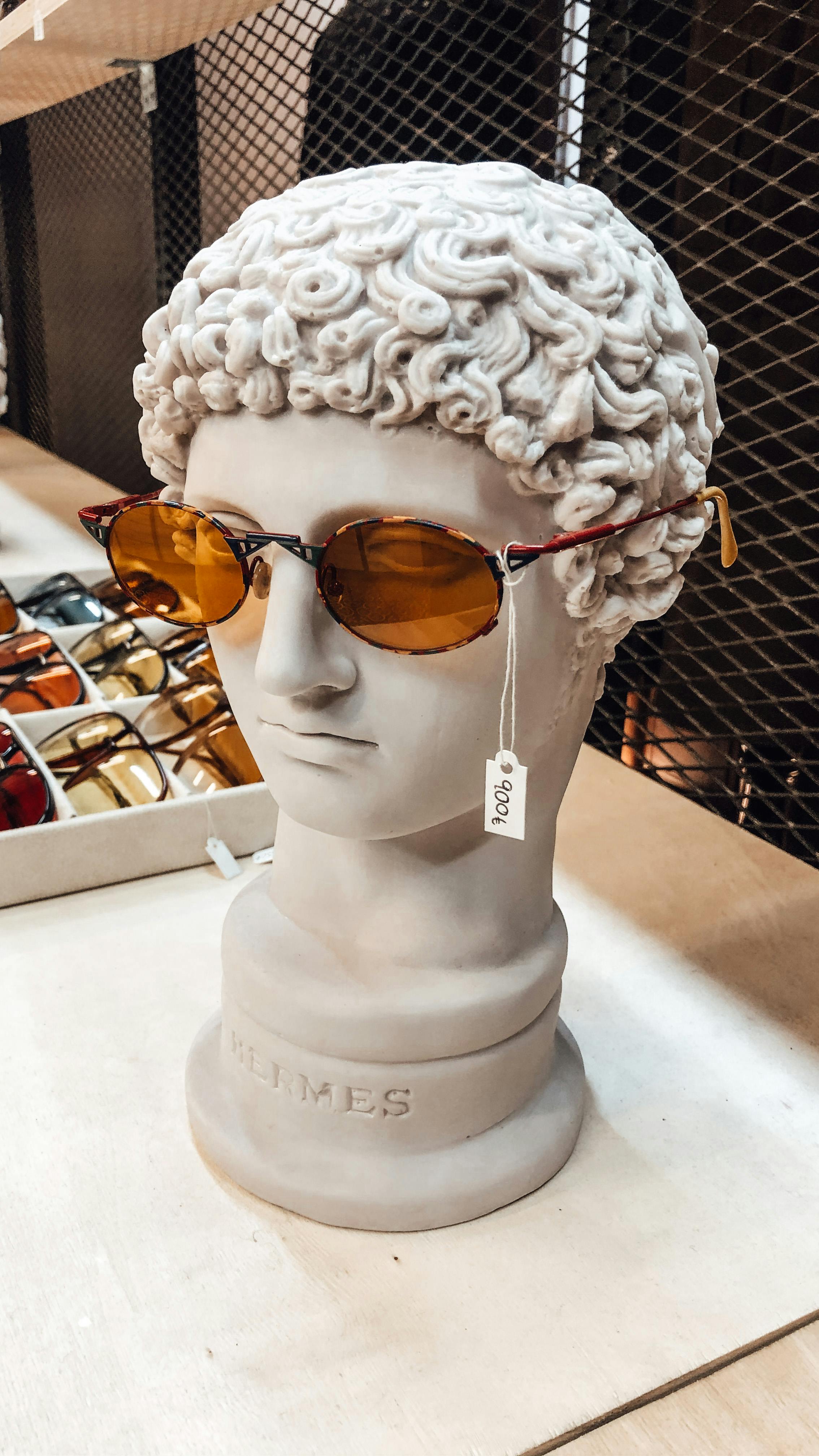 Vintage photograph of classic wayfarer-style sunglasses on a textured surface